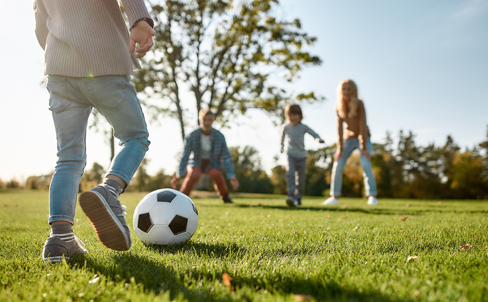 Family Playing Soccer Outdoors